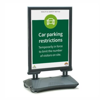 Water filled base pavement sign displaying car parking restrictions in a store car park